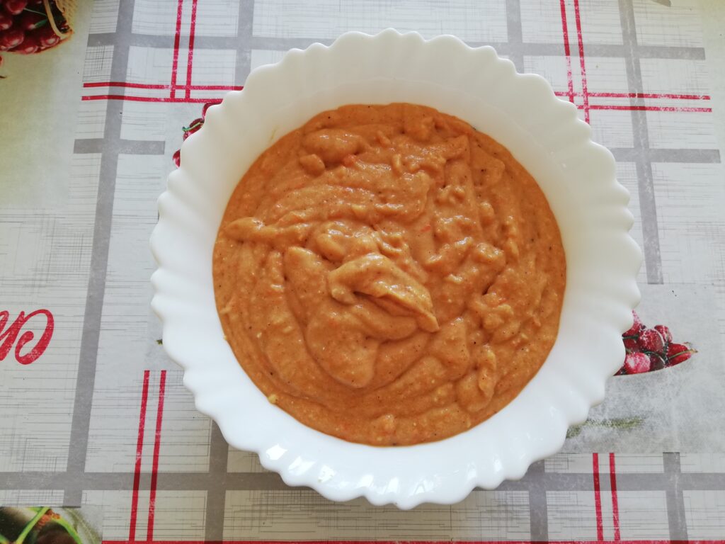 white bowl with sourdough pumpkin muffin batter