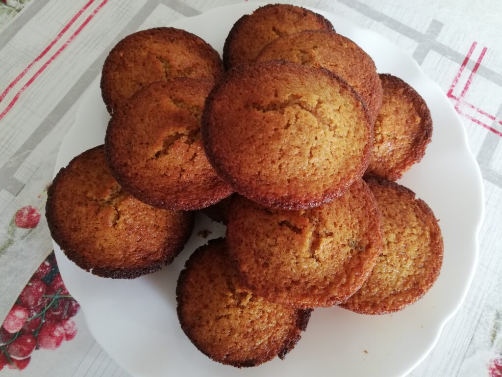 sourdough pumpkin muffins on a white serving plate