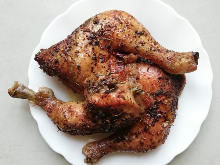 slow roasted chicken legs on a white serving plate