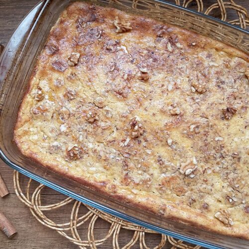 Pumpkin baked oatmeal in baking dish on wooden table