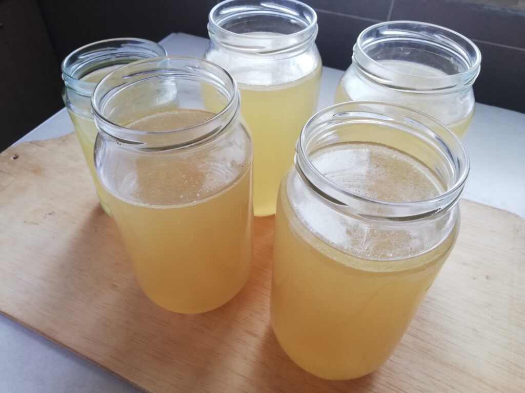 five jars of chicken broth made from an old hen