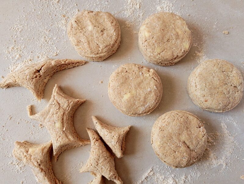 Cutting out biscuits on floured counter