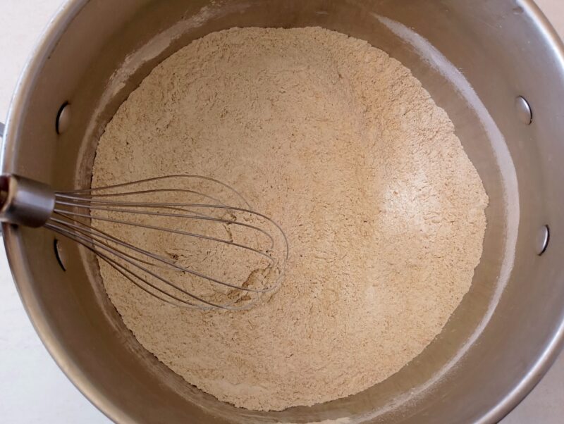 Whisking dry ingredients for sourdough biscuits in bowl