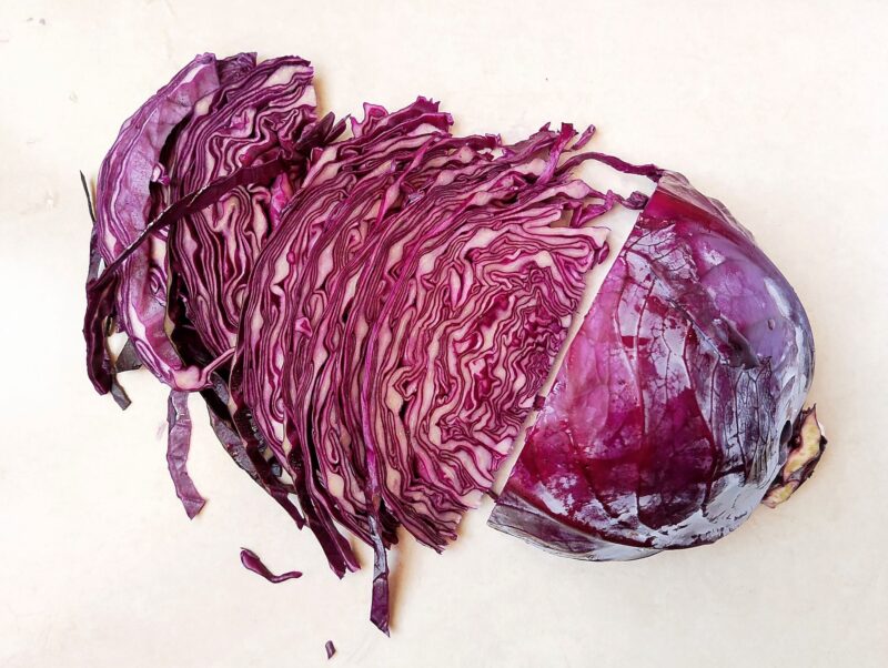 Slicing red cabbage thinly to make kraut