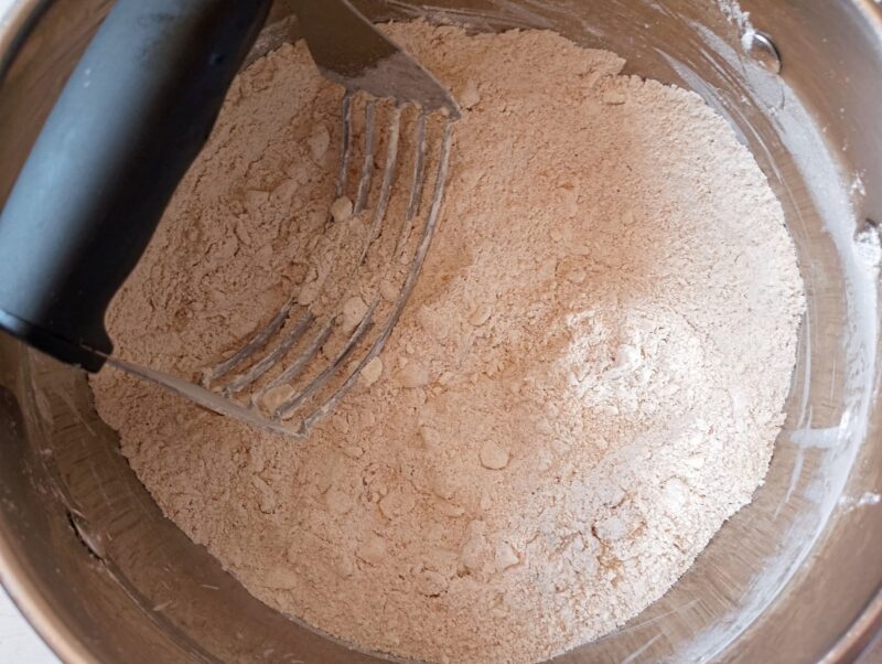 Cutting cold butter into flour with a pastry cutter
