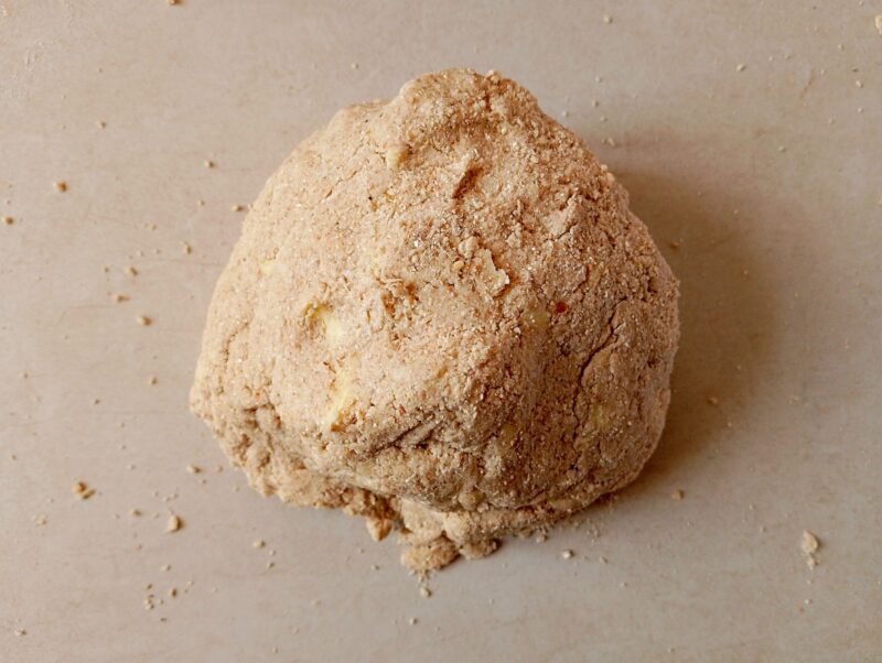 Pressing biscuit dough into a bowl