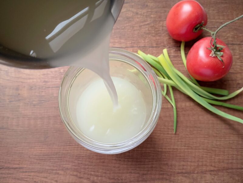 What to do with leftover whey: pouring whey into a mason jar
