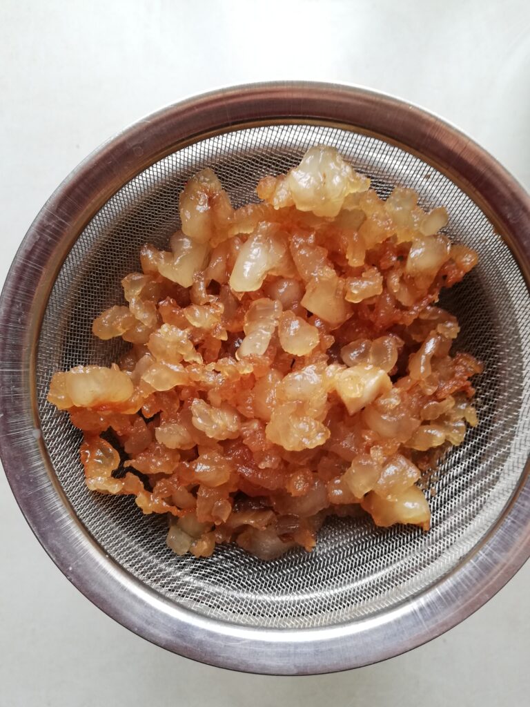 tallow cracklings on a small metal sieve