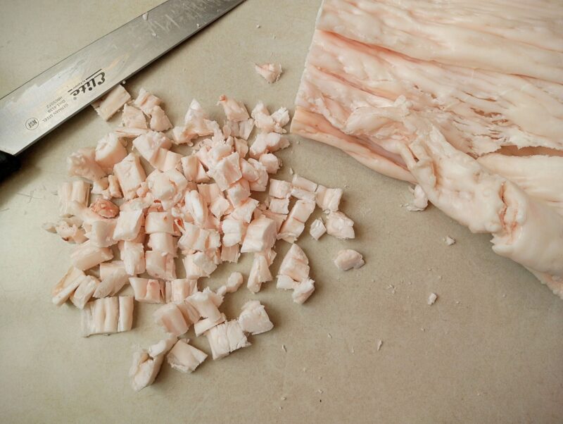 Chopping beef fat for rendering into tallow