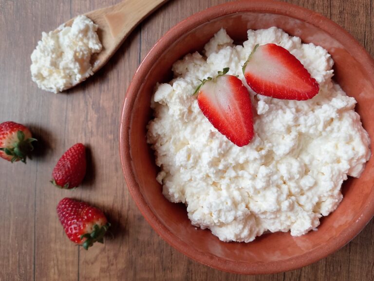 Raw milk cottage cheese recipe: bowl of cottage cheese on wooden table