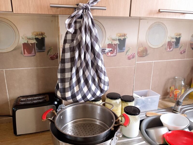 Hanging cottage cheese in cheesecloth to drain off whey