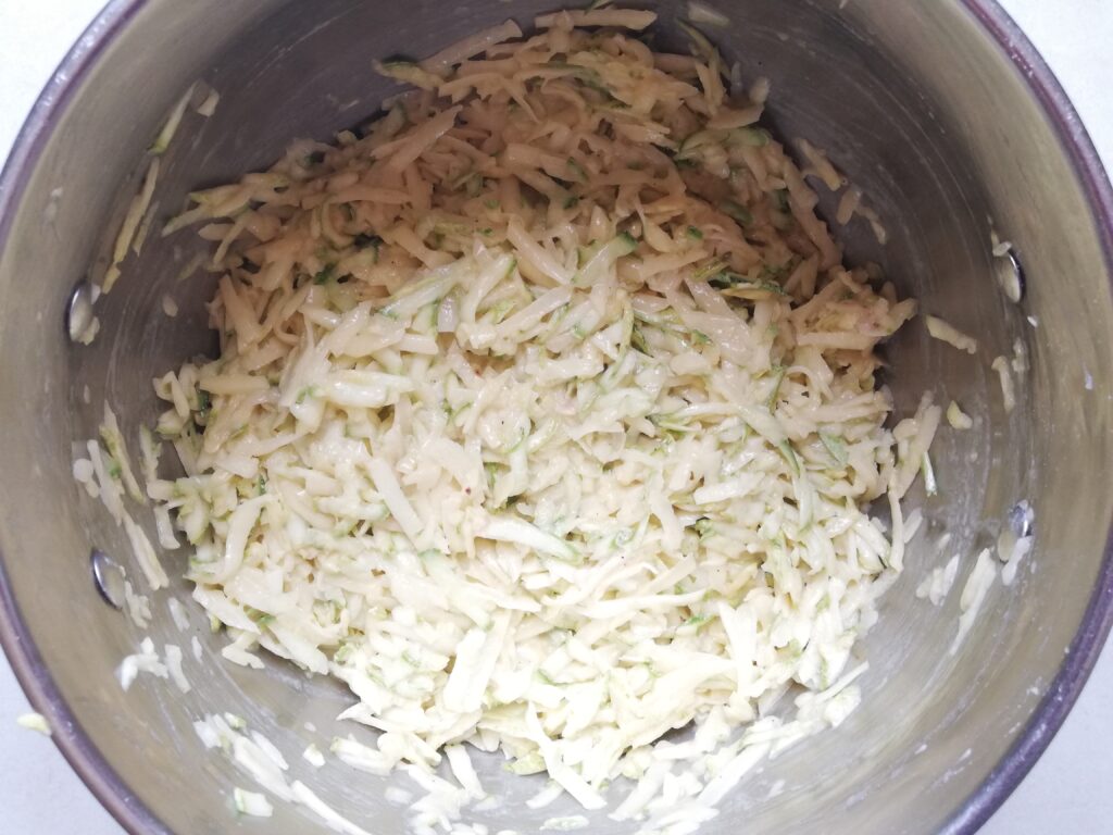 a metal pot with batter for zucchini and potato fritters 
