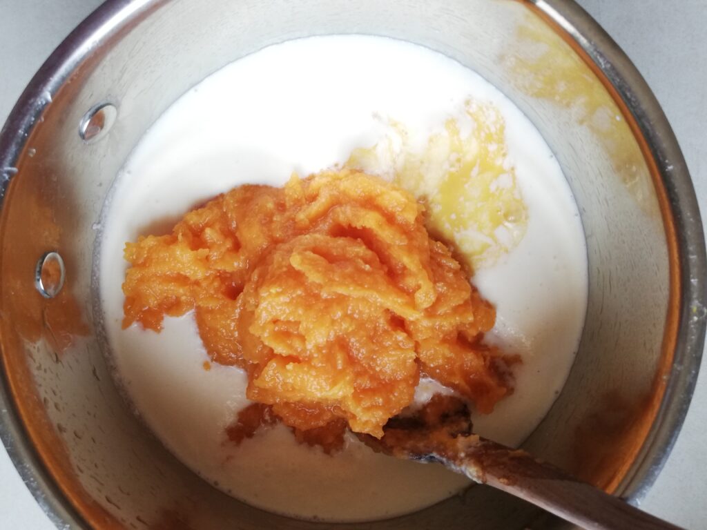 cream eggs and pumpkin puree in a metal mixing bowl