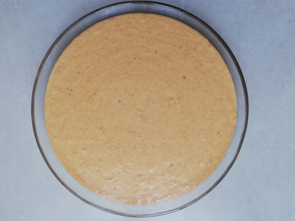 uncooked crustless pumpkin pie in a glass pie dish
