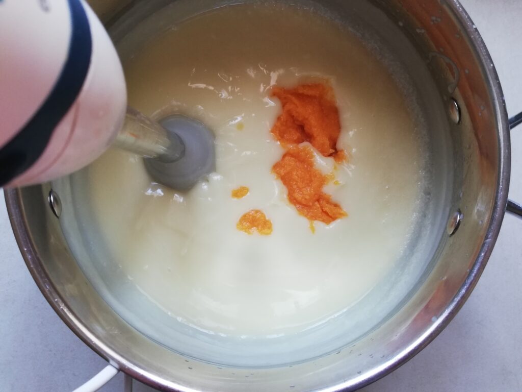 emulsified pumpkin spice soap with some pumpkin puree added in and a stick blender inserted