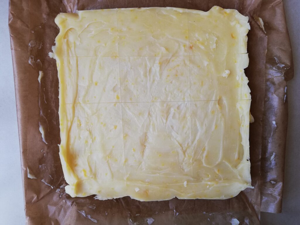 pumpkin spice soap on top of a sheet of baking paper with lines on top dividing it into bars