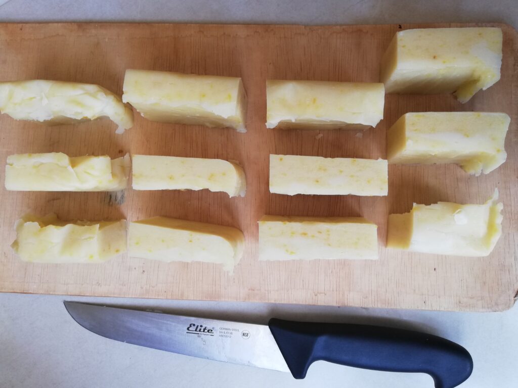 bars of pumpkin spice soap on a wooden tray with a chefs knife on the side