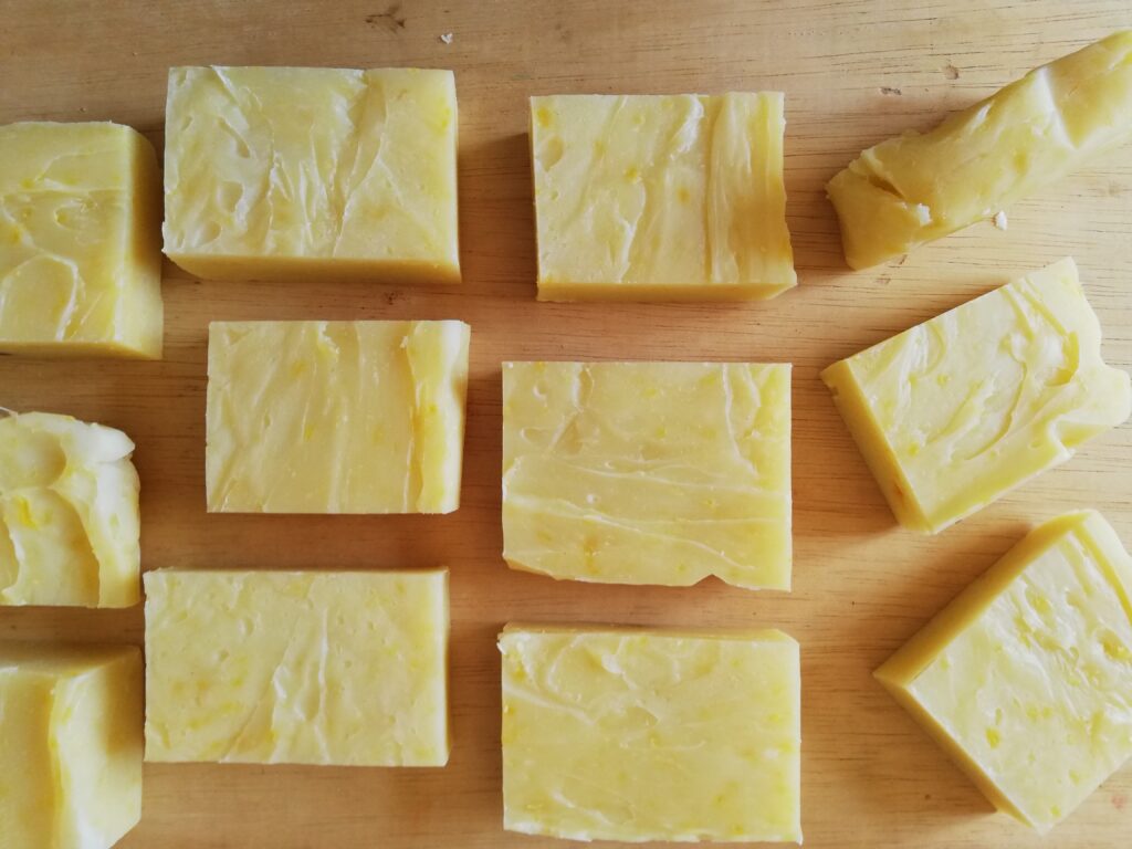 bars of pumpkin spice soap arranged in rows on a wooden board