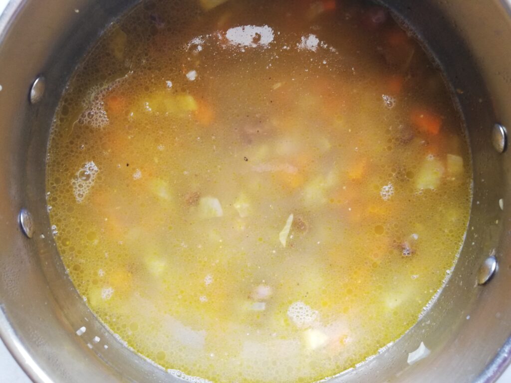 barley soup with chicken hearts cooking in a pot