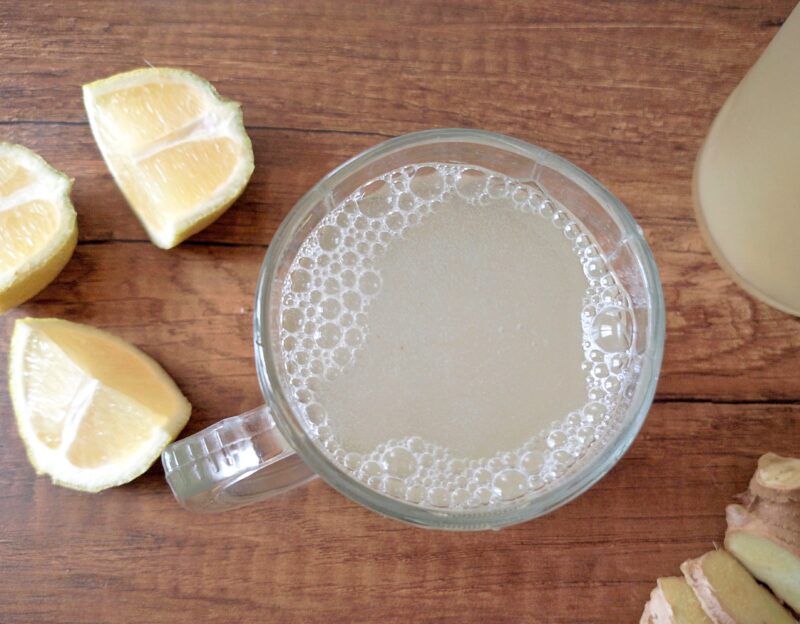 Glass of chilled ginger bug soda with bubbles on surface