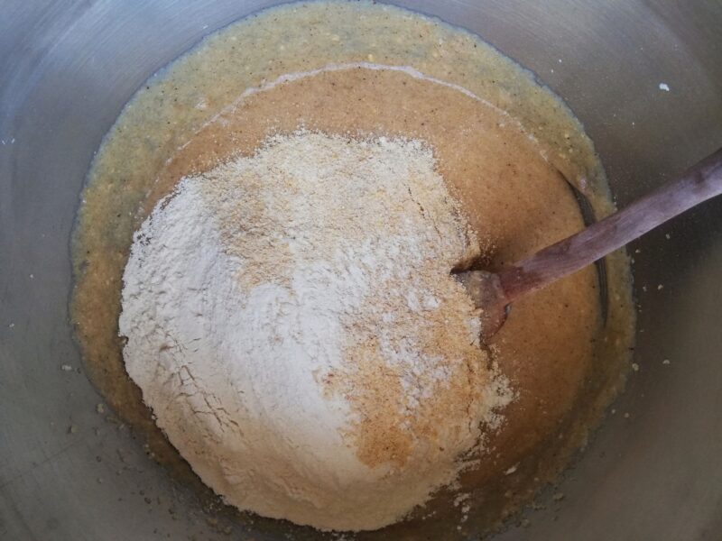 Adding all purpose flour and whole wheat flour to muffin batter