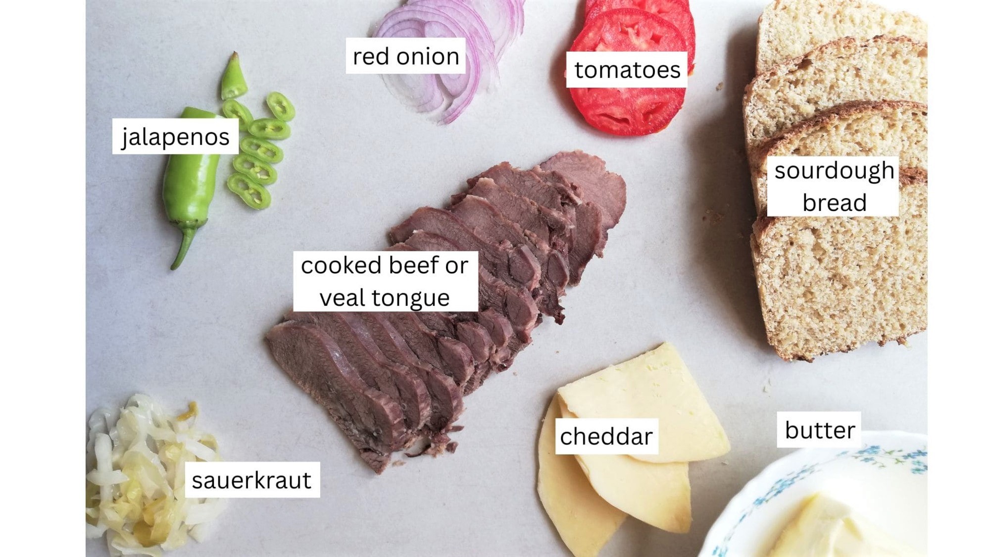 Ingredients for beef tongue sandwiches arranged on the counter
