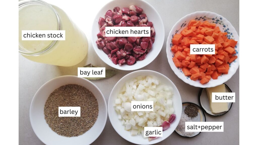 a jar of chicken stock a bowl of chicken hearts a bowl of chopped carrots a piece of butter some salt and pepper in a jar lid a bowl of onions and a few garlic cloves a bowl of barley and a bay leaf