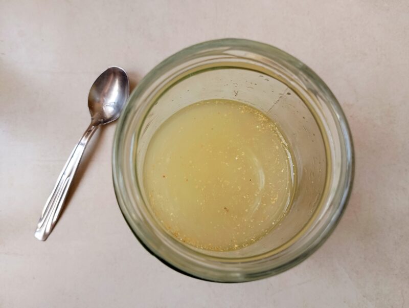 Mixing ingredients for ginger bug starter in jar