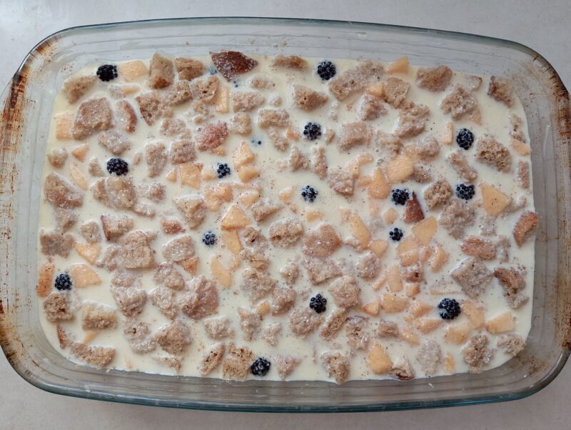 Pour custard over bread and fruit in baking dish