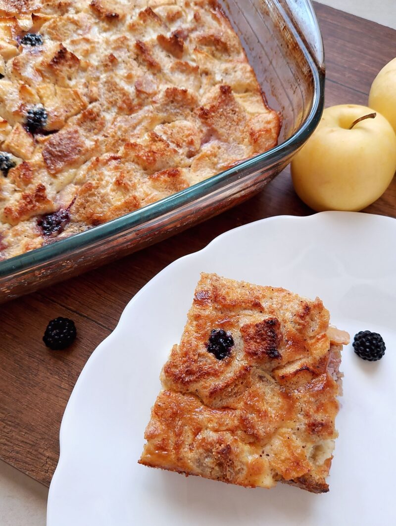 Slice of sourdough French toast bake on white serving plate