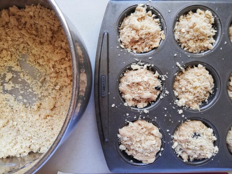 Topping sourdough applesauce muffins with streusel crumb topping