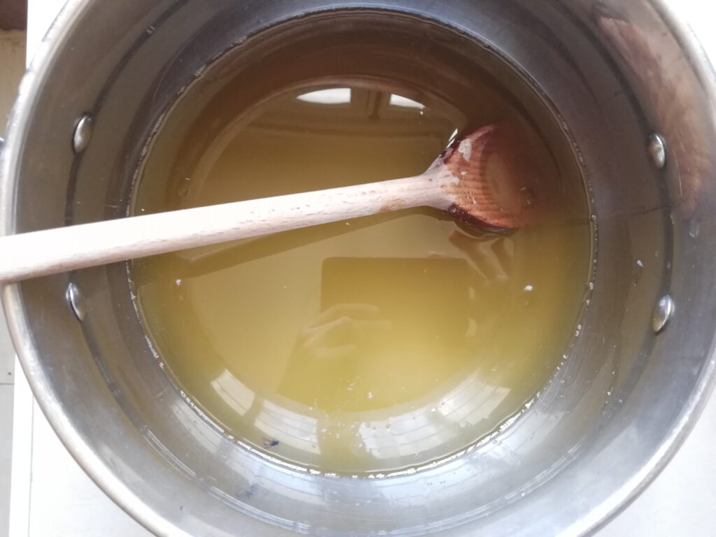 Adding olive oil into the melted fats