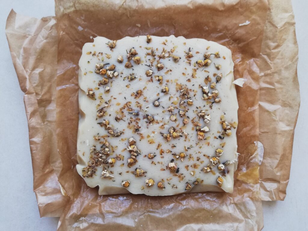 Cured cold process chamomile soap removed from the mold and ready to be cut into bars