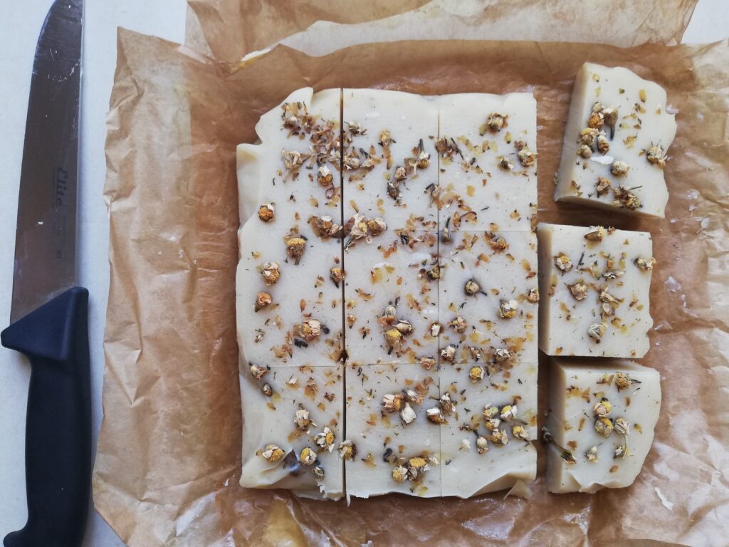 Cutting chamomile soap into bars with a sharp knife