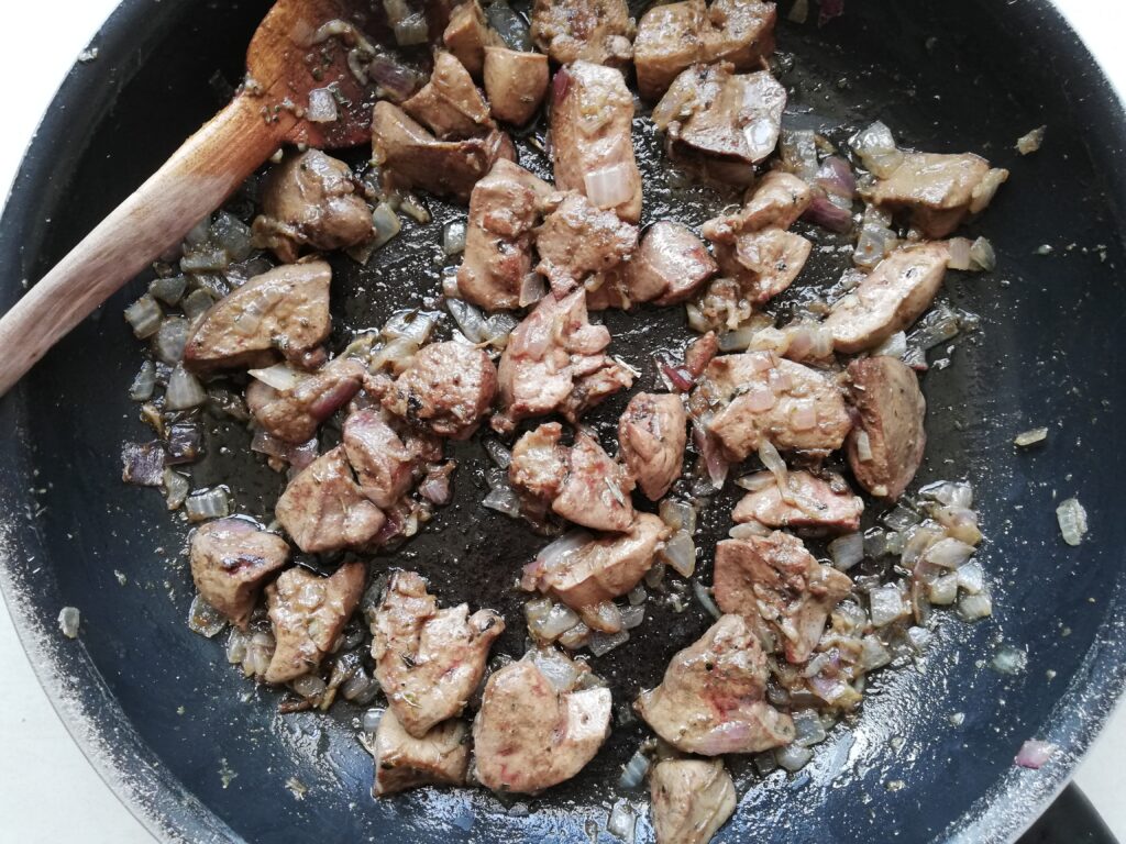 Cooked chicken livers, onions and garlic on a frying pan, ready to be blended into liver pate