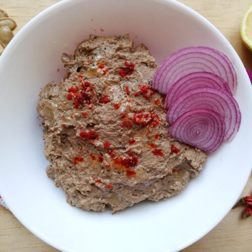 Mexican chicken liver pate garnished with chilli powder and sliced onions