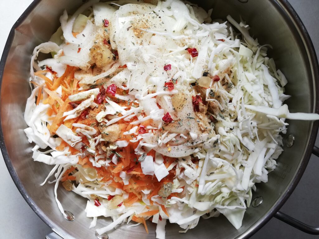 Ingredients for curtido in a large pot ready to be mixed