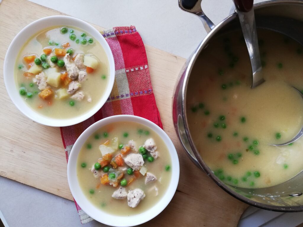Ladling the pot pie soup into bowls for serving