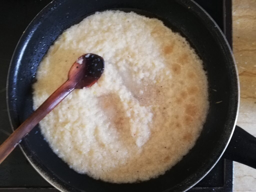 Sauteing minced onions and garlic in coconut oil in a frying pan