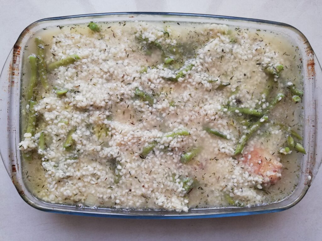 Assembled risotto in a casserole dish, ready to go into the oven