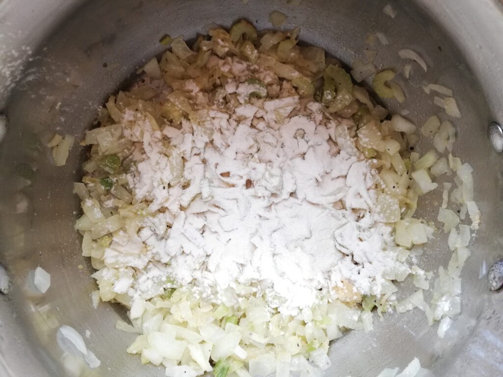 Adding flour to sauteed aromatics to thicken the pot pie soup
