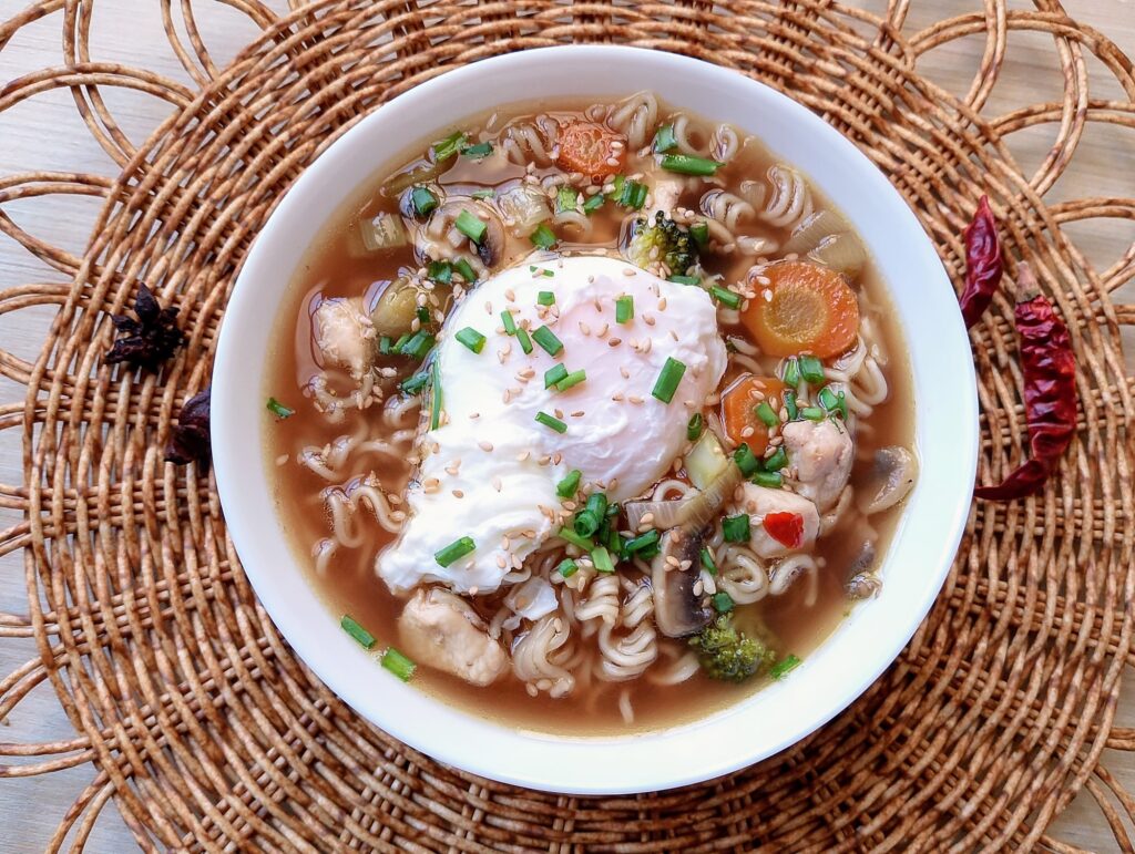 From scratch Chinese noodle soup served in a bowl garnished with green onions and toasted sesame seeds