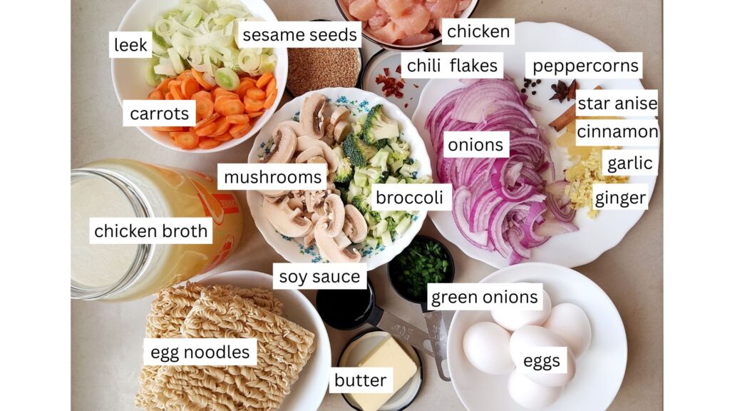 Ingredients for Chinese noodle soup arranged in containers on a counter top