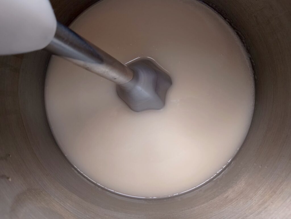 Blending the coconut oil soap with a stick blender until it reaches light trace
