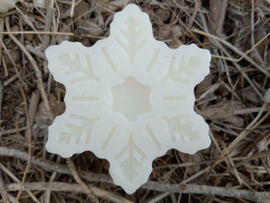 Cold process coconut oil soap on background of twigs