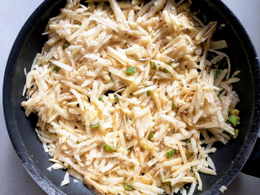 Sauteing shredded potatoes in sausage grease 