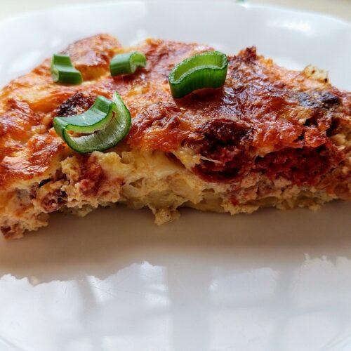 A slice of Amish breakfast casserole with sausage on a plate