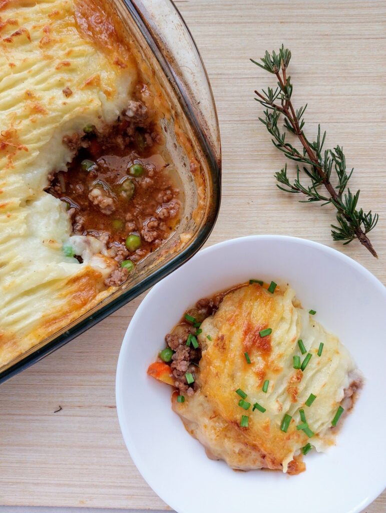 Cottage pie served in a bowl with a garnish of chives