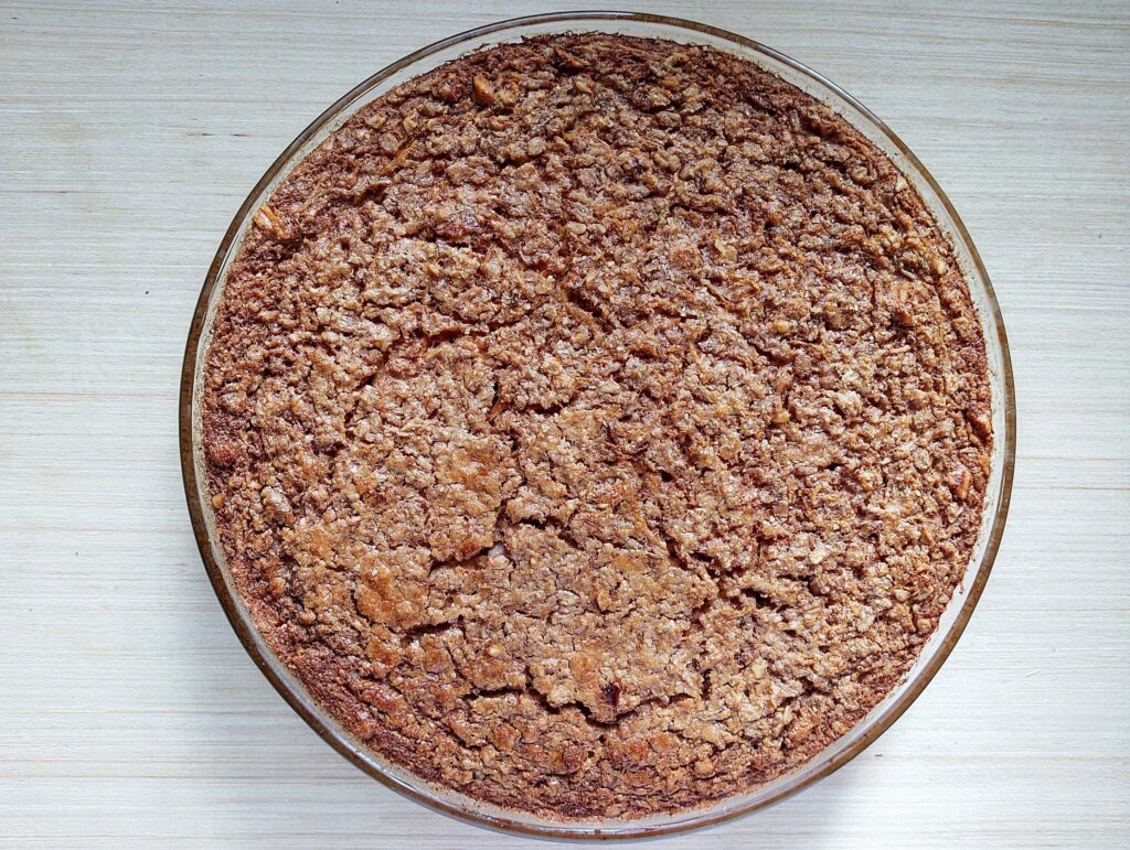 Freshly baked carrot cake baked oatmeal in a round glass baking dish