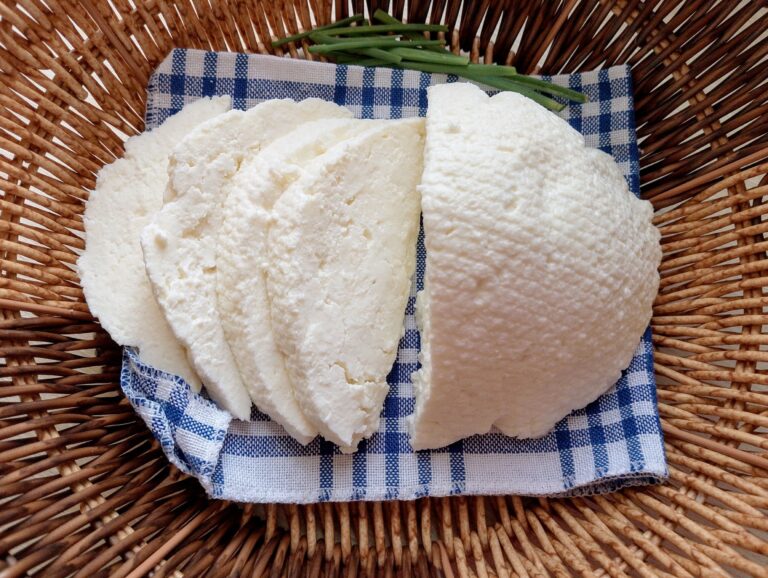 Raw milk paneer sliced in basket, with chives on the side